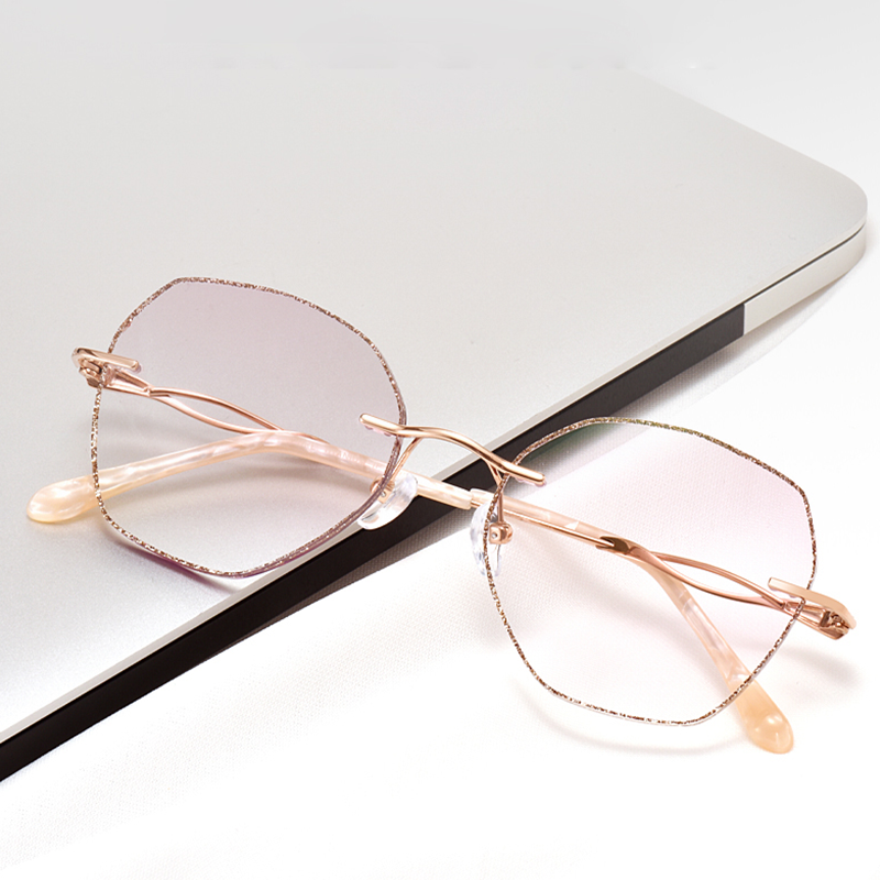 Elevate your style with MieMie Glitter Polygon Rimless Glasses. Featuring durable Metal frames in Champagne Gold with rhinestone embellishment. Our ALL-IN-ONE lenses offer blue light protection, anti-glare, and more at no extra cost. Perfect for fashion-forward Gen Z trendsetters!