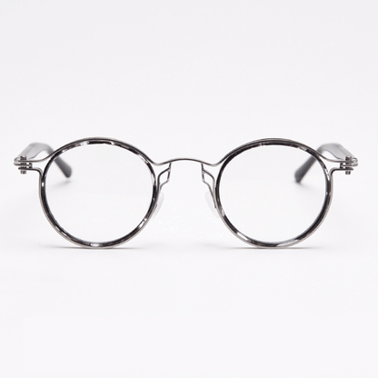 Featuring MieMie PRO003 modern steampunk round frame accented with metal stripes. Made from a seamless blend of lightweight acetate and sturdy metal, comes in 5 color: Black Tortoise, Bronze, Gold, Silver & Red. Multifunction all-in-one lenses. Embody sophistication and enhance any outfit.