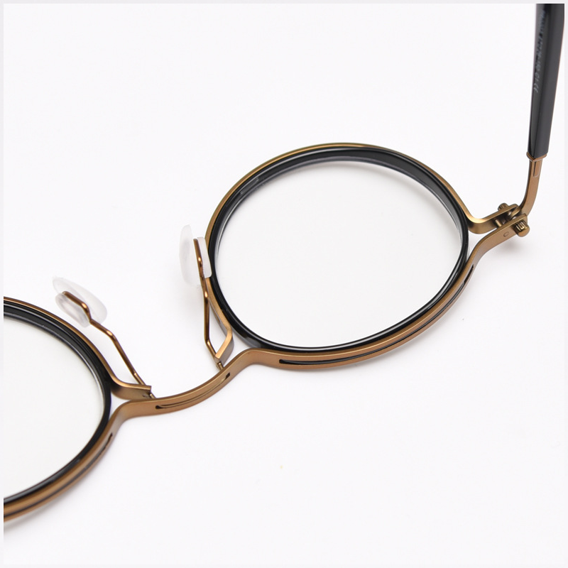 Featuring MieMie PRO003 modern steampunk round frame accented with metal stripes. Made from a seamless blend of lightweight acetate and sturdy metal, comes in 5 color: Black Tortoise, Bronze, Gold, Silver & Red. Multifunction all-in-one lenses. Embody sophistication and enhance any outfit.