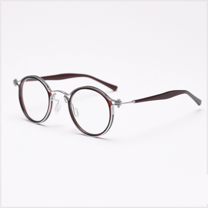 Featuring MieMie PRO003 modern steampunk round frame accented with metal stripes. Made from a seamless blend of lightweight acetate and sturdy metal, comes in 5 color: Black Tortoise, Bronze, Gold, Silver & Red. Multifunction all-in-one lenses. Embody sophistication and enhance any outfit.