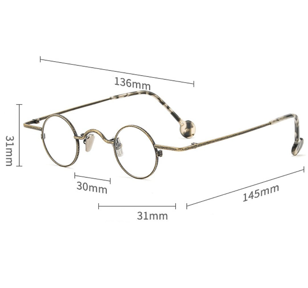 MieMie PR003 Round Steampunk Prescription Glasses—expertly crafted from quality metal alloy for unmatched durability and lightweight comfort. Their sleek design effortlessly combines modern style with timeless elegance, making them the perfect accessory for any occasion. Embrace clear vision and fashion-forward flair with these glasses that redefine what it means to look and feel your best. Available in 3 color: Black, Bronze & Silver