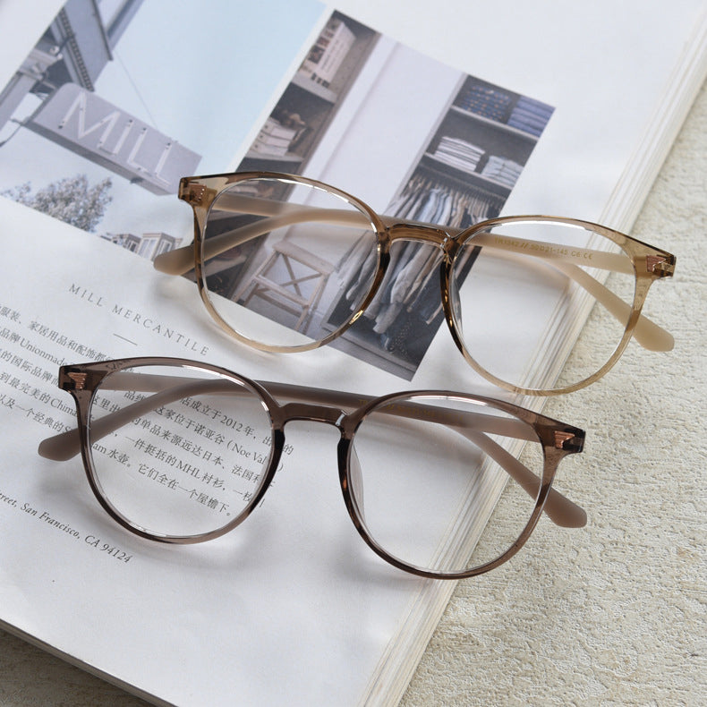 TR90 round frames in glossy black, transparent gray, white, olive green, coffee, cool-tone tea, gradient tea, and gradient coffee. Features ALL-IN-ONE lenses with multi-layer coatings: Anti-blue, Anti-allergic, scratch-resistant, anti-glare, and oil-resistant.