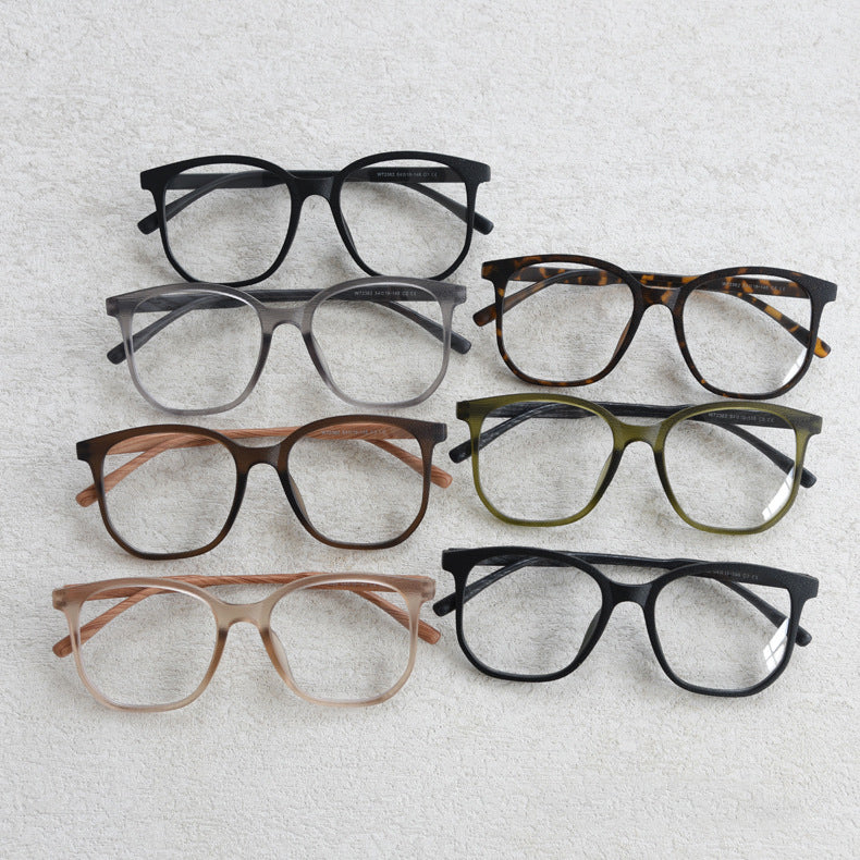 MieMie affordable TR90 wood-textured oversized eyeglass frames in multiple colors, including Brown, Coffee, Green, Grey, Tortoise, and Matte Black. Features ALL-IN-ONE lenses with multi-coating benefits like Anti-blue, Anti-scratch, Anti-glare, Anti-allergic, and Oil-resistant, offering a stylish and face-slimming look.