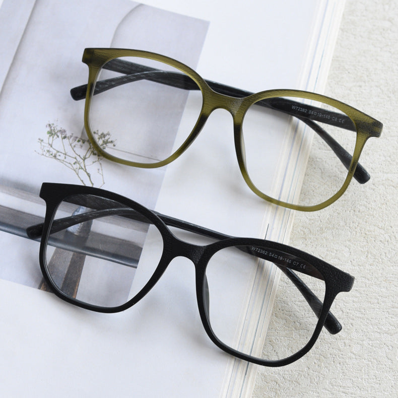 MieMie affordable TR90 wood-textured oversized eyeglass frames in multiple colors, including Brown, Coffee, Green, Grey, Tortoise, and Matte Black. Features ALL-IN-ONE lenses with multi-coating benefits like Anti-blue, Anti-scratch, Anti-glare, Anti-allergic, and Oil-resistant, offering a stylish and face-slimming look.