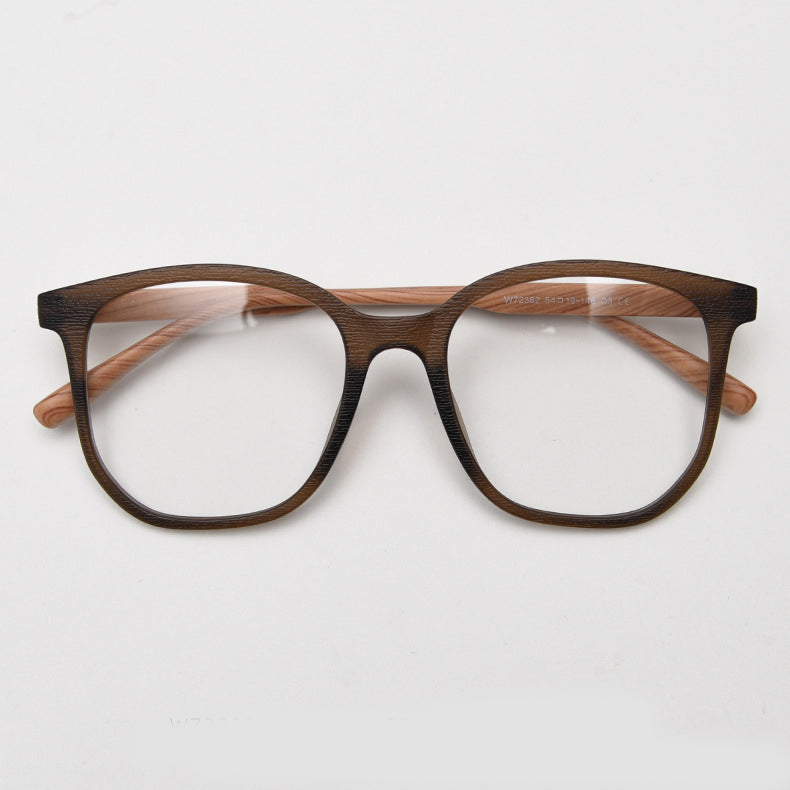 MieMie affordable TR90 wood-textured oversized eyeglass frames in multiple colors, including Brown, Coffee, Green, Grey, Tortoise, and Matte Black. Features ALL-IN-ONE lenses with multi-coating benefits like Anti-blue, Anti-scratch, Anti-glare, Anti-allergic, and Oil-resistant, offering a stylish and face-slimming look.