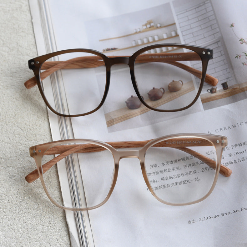 MieMie affordable TR90 wood-textured oversized eyeglass frames in multiple colors, including Brown, Coffee, Green, Grey, Tortoise, and Matte Black. Features ALL-IN-ONE lenses with multi-coating benefits like Anti-blue, Anti-scratch, Anti-glare, Anti-allergic, and Oil-resistant, offering a stylish and face-slimming look.