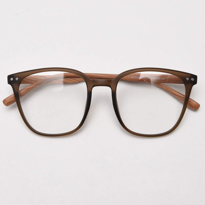 MieMie affordable TR90 wood-textured oversized eyeglass frames in multiple colors, including Brown, Coffee, Green, Grey, Tortoise, and Matte Black. Features ALL-IN-ONE lenses with multi-coating benefits like Anti-blue, Anti-scratch, Anti-glare, Anti-allergic, and Oil-resistant, offering a stylish and face-slimming look.