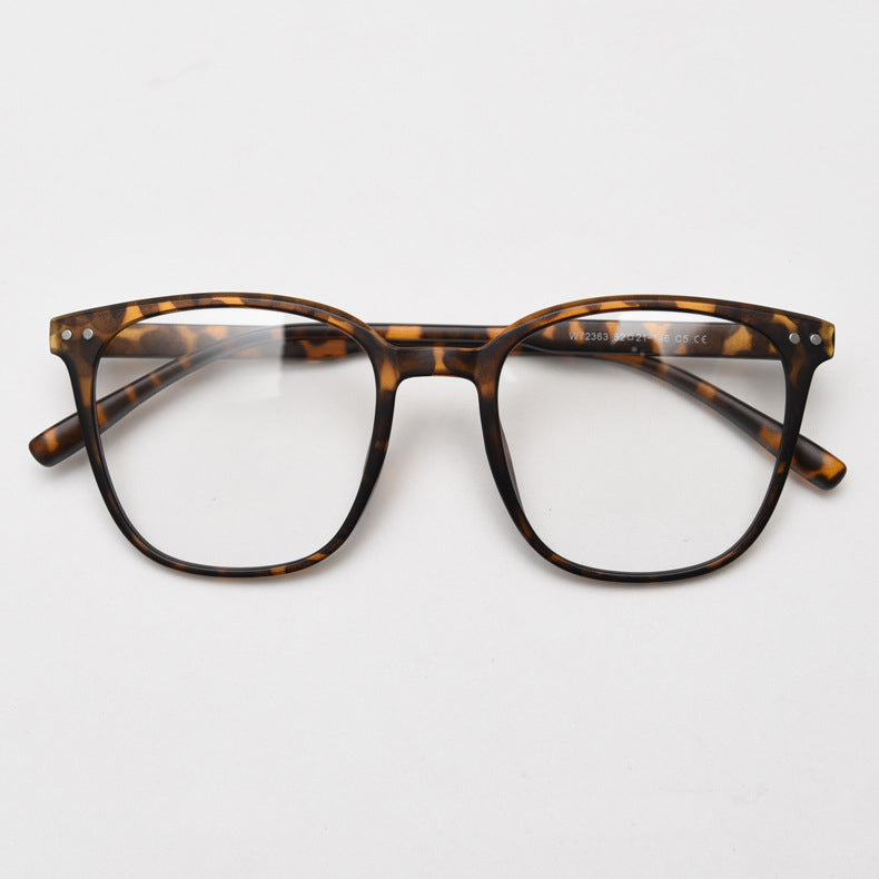 MieMie affordable TR90 wood-textured oversized eyeglass frames in multiple colors, including Brown, Coffee, Green, Grey, Tortoise, and Matte Black. Features ALL-IN-ONE lenses with multi-coating benefits like Anti-blue, Anti-scratch, Anti-glare, Anti-allergic, and Oil-resistant, offering a stylish and face-slimming look.