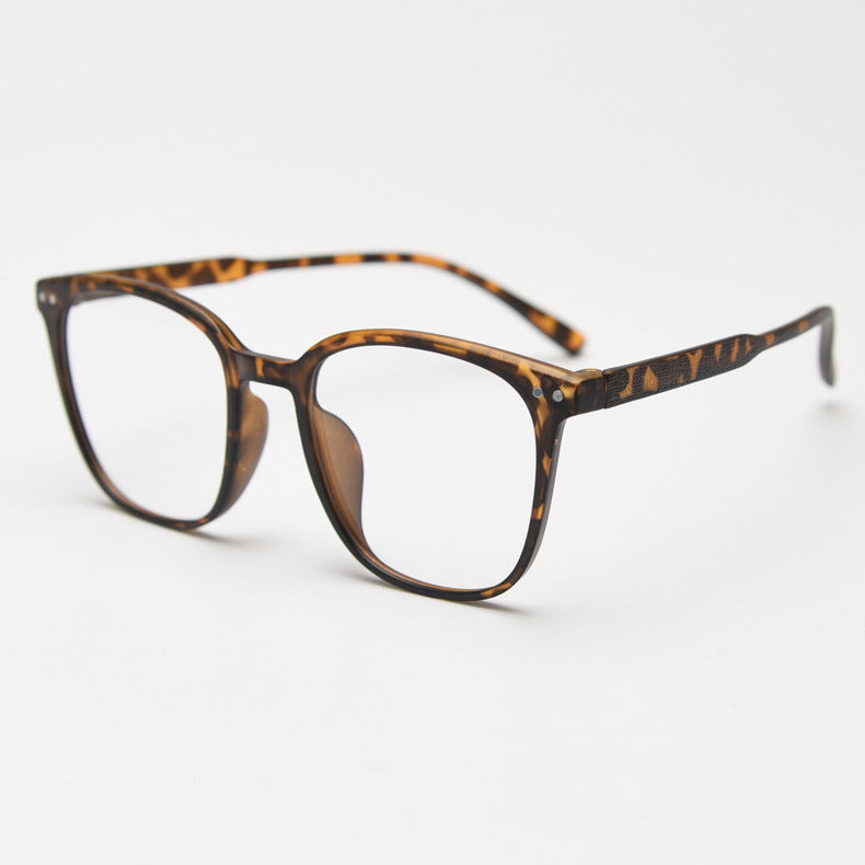 MieMie affordable TR90 wood-textured oversized eyeglass frames in multiple colors, including Brown, Coffee, Green, Grey, Tortoise, and Matte Black. Features ALL-IN-ONE lenses with multi-coating benefits like Anti-blue, Anti-scratch, Anti-glare, Anti-allergic, and Oil-resistant, offering a stylish and face-slimming look.