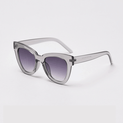 Elevate your style with MieMie SC004 Sunglasses in a striking cream shade for UV400 protection and bold frame. These chic cat-eye frames for women are crafted from lightweight PC material, providing both elegance and durability. Comes in distinctive color choices: pink, black, tortoise, grey, yellow, red, black tortoise, beige