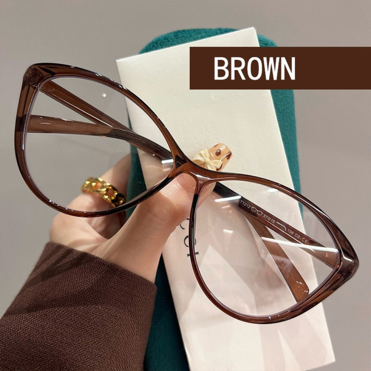 MieMie Bold Black Matte Cat-Eye Prescription Glasses featuring a sleek, stylish cat-eye shape with a bold matte black finish, designed for a modern and chic look, made from TR90 material,  PC001 Brown Color